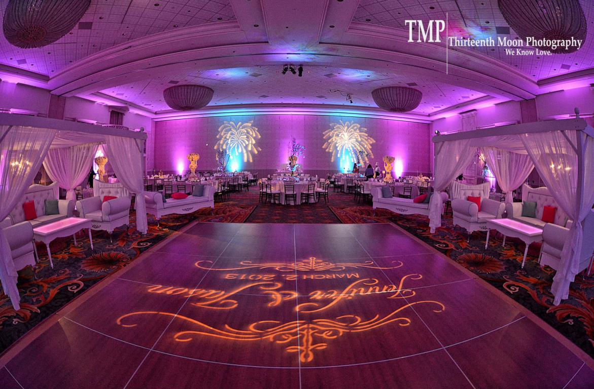 disney grand floridian wedding pink teal uplights centerpiece pin spot light custom wedding monogram on dance floor